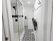 Elegant bathroom featuring black and white decorative tiles, shower and tiled wall and door to the vanity at 675 Liberty Church Rd., Loris, SC 29569