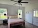 Bright bedroom with a ceiling fan, neutral carpet and walls, and nice natural light from the windows at 675 Liberty Church Rd., Loris, SC 29569