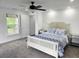 Bright bedroom with a window, neutral carpet, ceiling fan and stylish decor at 675 Liberty Church Rd., Loris, SC 29569