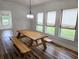 Bright dining area featuring a wooden picnic table and seating near the window at 675 Liberty Church Rd., Loris, SC 29569
