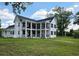 Charming home with covered porches, black shutters, and mature trees on a large lot at 675 Liberty Church Rd., Loris, SC 29569