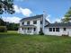 A beautiful home with a covered porch, black shutters, and green grass on a sunny day at 675 Liberty Church Rd., Loris, SC 29569