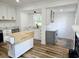 Bright kitchen featuring white cabinets, an island with a butcher block top, and stainless steel appliances at 675 Liberty Church Rd., Loris, SC 29569