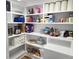 Custom pantry shelving with an array of food, paper products, and small appliances for efficient organization at 675 Liberty Church Rd., Loris, SC 29569