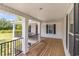 Spacious porch with wood decking, black railings and view of a well-maintained yard at 675 Liberty Church Rd., Loris, SC 29569