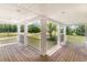 Covered porch featuring wood decking, black railing and views of the lush surroundings at 675 Liberty Church Rd., Loris, SC 29569