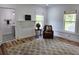Charming sitting room with paneled walls, wood floors, and a cozy chair next to a decorative fireplace at 675 Liberty Church Rd., Loris, SC 29569