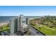 An aerial view of The Beach House Resort with the ocean and the shoreline visible, clear blue skies, and sunny weather at 6804 N Ocean Blvd. # 1049, Myrtle Beach, SC 29572