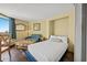 This is a bedroom with a large window, a small sofa, a coffee table, and a bed with white sheets and blue accents at 6804 N Ocean Blvd. # 1049, Myrtle Beach, SC 29572