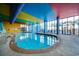 A spacious indoor pool area featuring bright lighting, comfortable lounge chairs, and a tropical ambiance at 6804 N Ocean Blvd. # 1049, Myrtle Beach, SC 29572