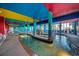 A colorful indoor pool with a lazy river surrounded by tropical decor and seating areas at 6804 N Ocean Blvd. # 1049, Myrtle Beach, SC 29572