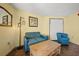 This image shows the living area of a room, with a sofa, a chair, a wooden coffee table, and a lamp at 6804 N Ocean Blvd. # 1049, Myrtle Beach, SC 29572