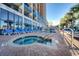 Outdoor hottub and pool with palm trees and lounge chairs at 6804 N Ocean Blvd. # 1049, Myrtle Beach, SC 29572