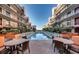 A tranquil pool area nestled between apartment buildings, complete with lounge chairs and tables at 6804 N Ocean Blvd. # 1049, Myrtle Beach, SC 29572