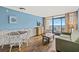 Cozy living room with dining area, balcony access, and ocean views at 6804 N Ocean Blvd. # 1133, Myrtle Beach, SC 29572