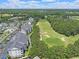 Aerial view of the community and golf course surrounded by mature trees at 719 Shearwater Ct. # 301, Murrells Inlet, SC 29576