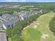 Aerial view of property featuring golf course, pool, pond and ample parking spaces at 719 Shearwater Ct. # 301, Murrells Inlet, SC 29576