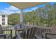 Inviting balcony with seating, offering beautiful views of the creek and trees at 719 Shearwater Ct. # 301, Murrells Inlet, SC 29576