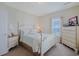 Bright bedroom with white furniture and coastal-themed decorations at 719 Shearwater Ct. # 301, Murrells Inlet, SC 29576