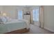 Cozy bedroom with soothing colors, plush bedding, and plenty of natural light at 719 Shearwater Ct. # 301, Murrells Inlet, SC 29576