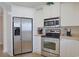 Well-lit kitchen features stainless steel appliances, white cabinets, and sleek countertops at 719 Shearwater Ct. # 301, Murrells Inlet, SC 29576