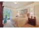 Relaxing bedroom featuring tray ceiling, balcony access, and ample natural light at 719 Shearwater Ct. # 301, Murrells Inlet, SC 29576