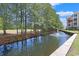 Scenic water fountain in the pond framed by lush trees and a serene walking path at 719 Shearwater Ct. # 301, Murrells Inlet, SC 29576