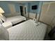 Cozy bedroom featuring two beds, a dresser, and a mounted TV at 7500 N Ocean Blvd. # 6120, Myrtle Beach, SC 29572
