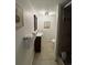 Bathroom with a shower stall, vanity with towels, neutral tile floor and decorative art on the wall at 7509 N Ocean Blvd. # 1205, Myrtle Beach, SC 29572