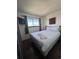 Bedroom featuring a TV, window with a view, and a white bed with towels folded into swans at 7509 N Ocean Blvd. # 1205, Myrtle Beach, SC 29572