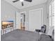 Bedroom featuring ceiling fan, TV, closet, door to bathroom, and a modern black bed at 830 Shine Ave. # 28 R8, Myrtle Beach, SC 29577