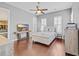 Bedroom with hardwood floors, ceiling fan, and plantation shutters, with coastal decor and TV at 830 Shine Ave. # 28 R8, Myrtle Beach, SC 29577