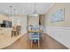 Dining area adjacent to the kitchen, featuring a modern chandelier and staircase in the background at 830 Shine Ave. # 28 R8, Myrtle Beach, SC 29577