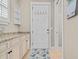 Entryway features granite countertops, white cabinets, coat hooks, and a charming starfish rug at 830 Shine Ave. # 28 R8, Myrtle Beach, SC 29577
