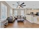 Comfortable living room with a large sectional sofa, modern ceiling fan, and an open layout to the kitchen at 830 Shine Ave. # 28 R8, Myrtle Beach, SC 29577