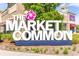 Daytime shot of The Market Common sign in front of stores and restaurants at 830 Shine Ave. # 28 R8, Myrtle Beach, SC 29577