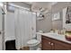 Bathroom with shower/tub combination, decorative shelves, a framed mirror, and dark-wood vanity at 9232 Goodwill Ct., Myrtle Beach, SC 29579