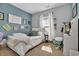 Cozy bedroom with blue accent wall, white furnishings, and lots of character at 9232 Goodwill Ct., Myrtle Beach, SC 29579