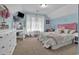 Spacious bedroom featuring a vanity, white furnishings, light blue walls, and a large window at 9232 Goodwill Ct., Myrtle Beach, SC 29579