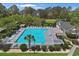 Aerial view of the community pool and clubhouse area with plenty of seating and lush landscaping at 9232 Goodwill Ct., Myrtle Beach, SC 29579