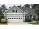Charming home featuring gray siding, a two-car garage, and manicured landscaping at 9232 Goodwill Ct., Myrtle Beach, SC 29579