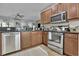 Functional kitchen with updated stainless steel appliances, dark cabinetry, and granite countertops at 9232 Goodwill Ct., Myrtle Beach, SC 29579