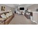 Spacious living room with comfortable brown couches, a flat-screen TV, and plush carpeting at 9232 Goodwill Ct., Myrtle Beach, SC 29579