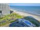 Breathtaking aerial view of condo, beachfront, and sparkling community pool offering ultimate relaxation and luxury at 9820 Queensway Blvd. # 1603, Myrtle Beach, SC 29572