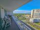 Inviting balcony with comfortable seating, providing serene views of the lush surroundings and distant buildings at 9820 Queensway Blvd. # 1603, Myrtle Beach, SC 29572