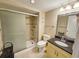 This bathroom has a shower with glass doors and a tile surround, along with a toilet and vanity with granite countertop at 9820 Queensway Blvd. # 1603, Myrtle Beach, SC 29572