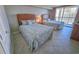 Bedroom view of two beds with blue seashell patterned covers with a view of the city at 9820 Queensway Blvd. # 1603, Myrtle Beach, SC 29572