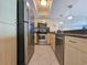 This modern kitchen features stainless steel appliances, tile floors and beautiful stone countertops at 9820 Queensway Blvd. # 1603, Myrtle Beach, SC 29572