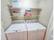 Functional laundry room with washer, dryer, and shelving for storage at 9820 Queensway Blvd. # 1603, Myrtle Beach, SC 29572
