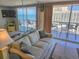 Inviting living room featuring ocean views and balcony access, perfect for relaxing and enjoying the coastal lifestyle at 9820 Queensway Blvd. # 1603, Myrtle Beach, SC 29572